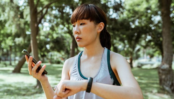 A person using a black smartphone during a jog. — Pexels