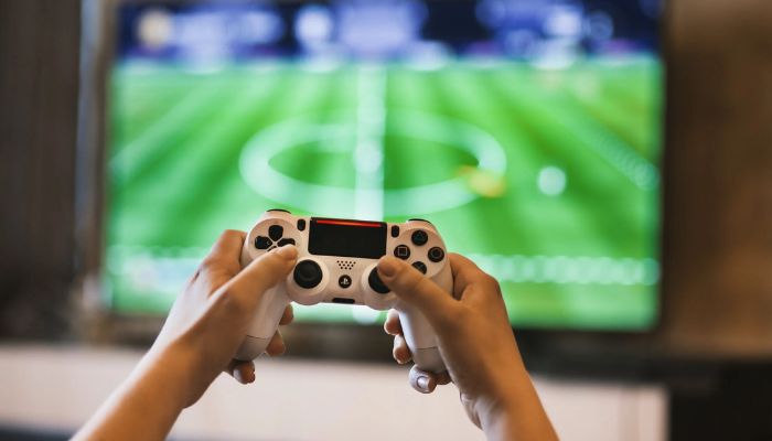 Person holding a game pad. — Pexels