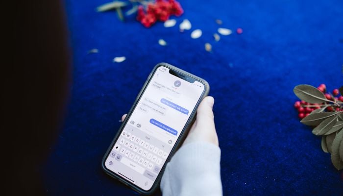 A person texting someone on their iPhone. — Pexels
