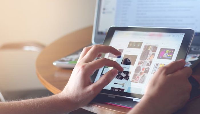 A person using an iPad. — Unsplash