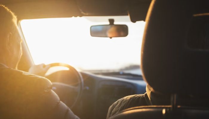 A person driving a car. — Unsplash