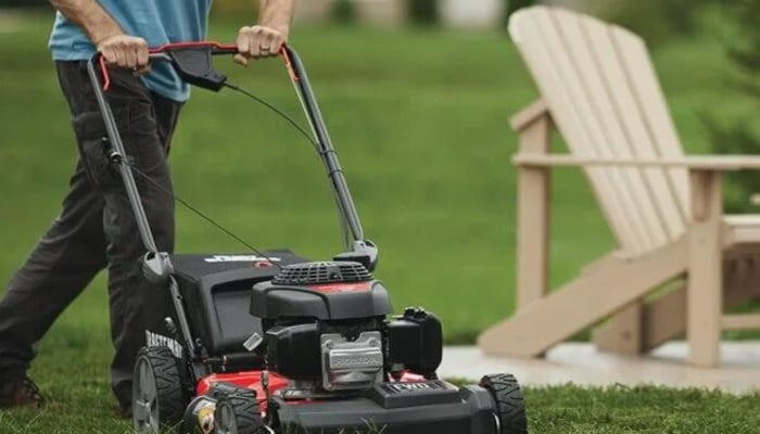 An undated image of a man mowing the grass with an electric lawn mower . —Thetechedvocate