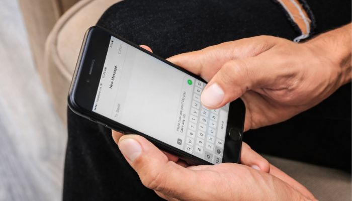 An undated image illustrating a person using Messenger. — Canva