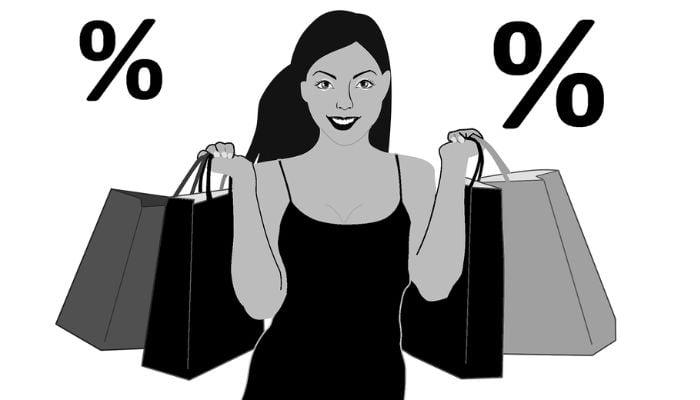 The illustration shows an animated woman holding shopping bags with percentage symbols in the background. — Pixabay