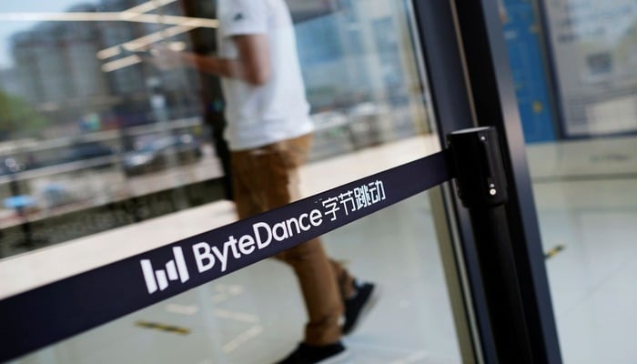 A man walks by a logo of Bytedance, the China-based company which owns the short video app TikTok, at its office in Beijing, China July 7, 2020. — Reuters