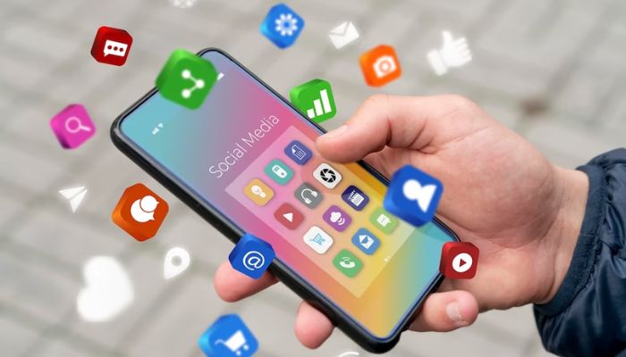 The image shows different social media app icons revolving around a phone. — Freepik