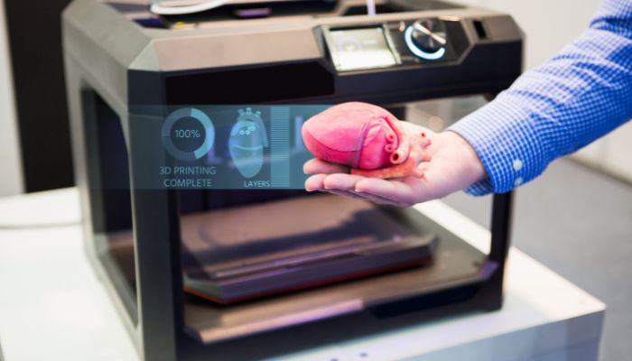 An undated image illustrating a person holding a 3D-printed heart. — Canva
