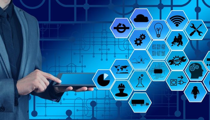 The image shows a person using a tablet and icons of different tech features. — Pixabay