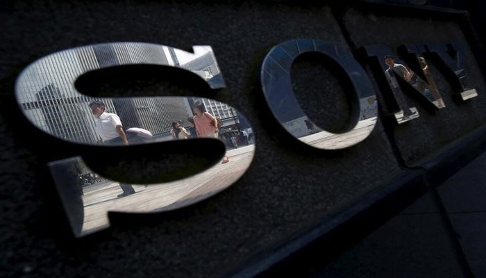 Pedestrians are reflected in a logo of Sony Corp outside its showroom in Tokyo, Japan, June 23, 2015. — Reuters