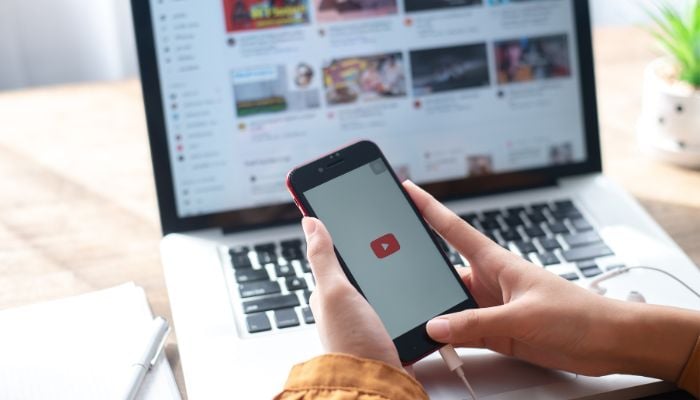 An undated image of a person using YouTube. — Canva