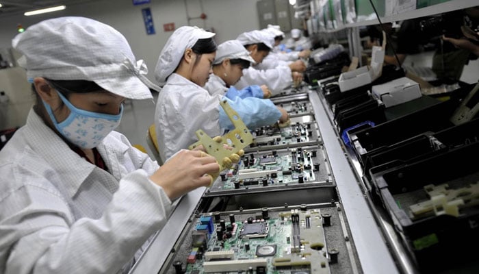 An undated image of women working in an assembly plant. — CNBC