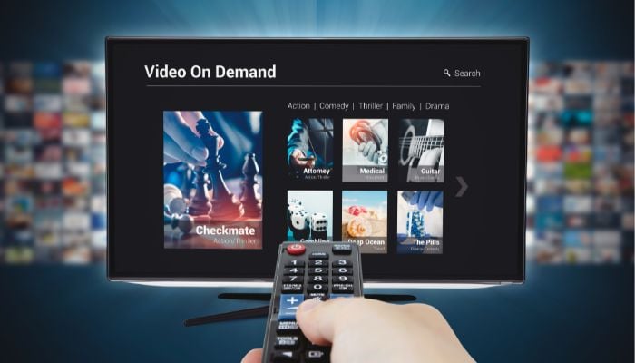 An undated image illustrating a person using TV streaming service. — Canva