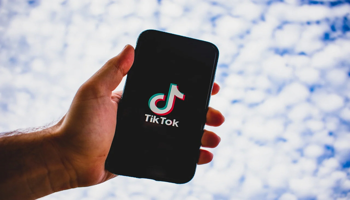 An undated image displays TikTok logo on a mobile screen. — Canva