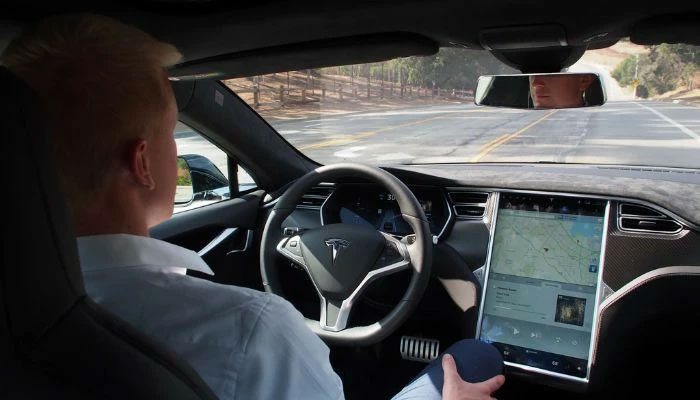 A person driving Tesla.— WIRED