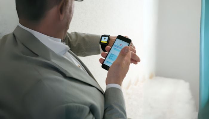 An undated image illustrating a person using a smartwatch. — Canva
