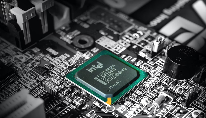 The image shows an Intel chip placed on a motherboard. — Unsplash