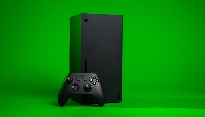 The image shows Xbox and controller on a green background. — Unsplash