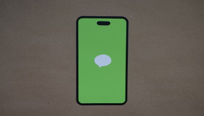 A representational image displays iMessage logo on a mobile screen. — Unsplash