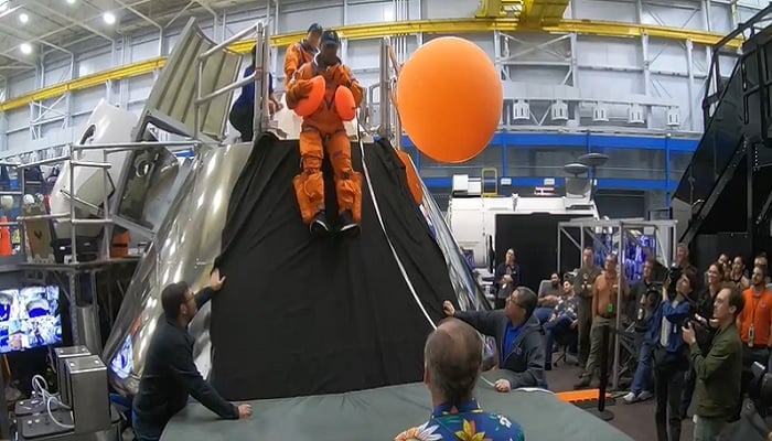 The image is a screenshot of a NASA video showing astronauts preparing for a mission. X/@NASA_Johnson