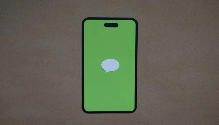 A representational image displays iMessage logo on a mobile screen. — Unsplash
