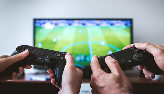 An image displaying two people playing a video game — Unsplash