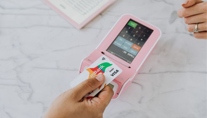 An undated image of a person using a prepaid debit card. — Canva