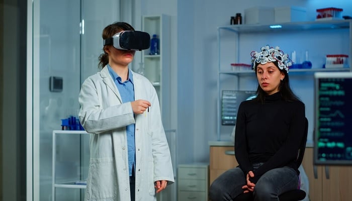 The image shows a researcher wearing a VR headset. — Freepik