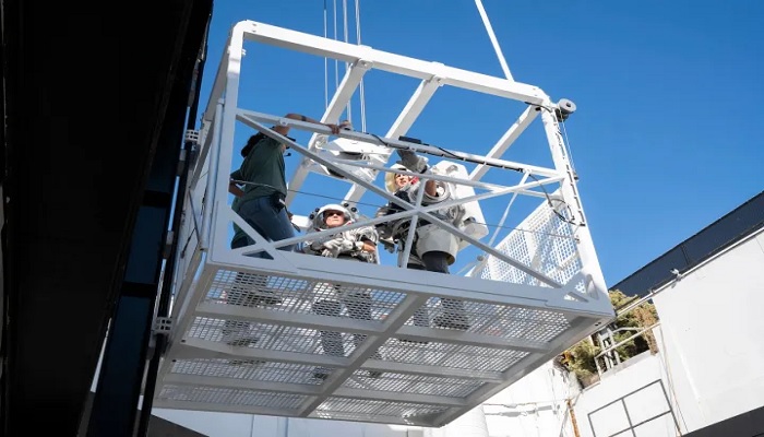 The image shows NASA astronauts on a space elevator. — Space X