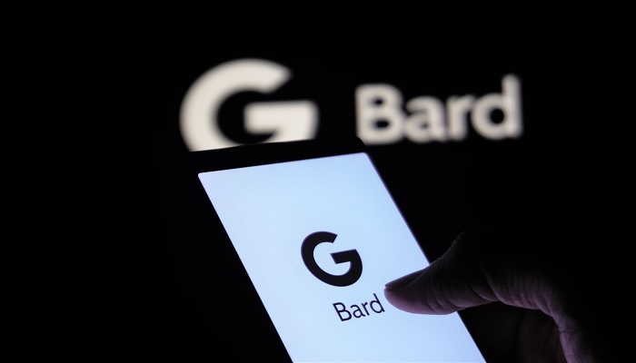 The image shows a person using Google Bard on phone. — Unsplash