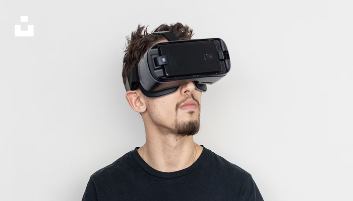 The image shows a guy wearing virtual reality headset. — Unsplash