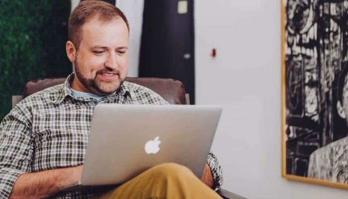 A person using an Apple laptop. — Unsplash