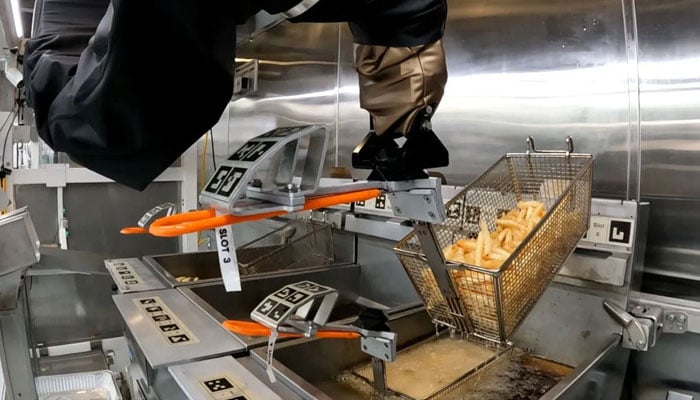 A robot arm cooking fries on a Flippy fry station. — Miso Robotics