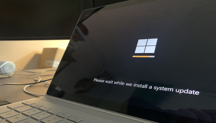 The image displays Microsoft logo on a laptop screen. — Unsplash