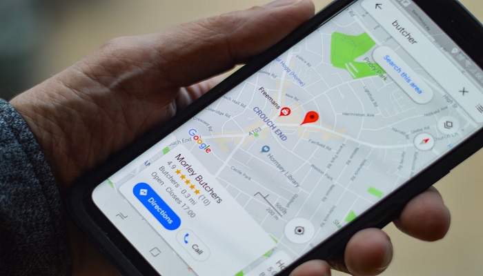 The image shows a person using Google Map. — Unsplash