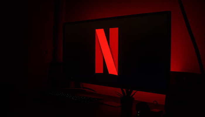 The image shows Netflix logo on a TV screen. — Unsplash