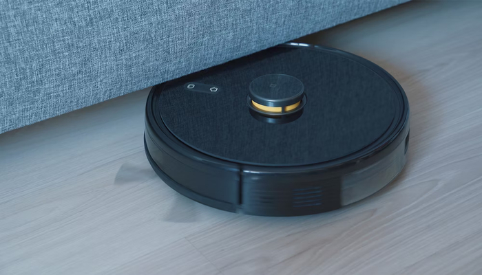 The image shows a robotic vacuum. — Unsplash
