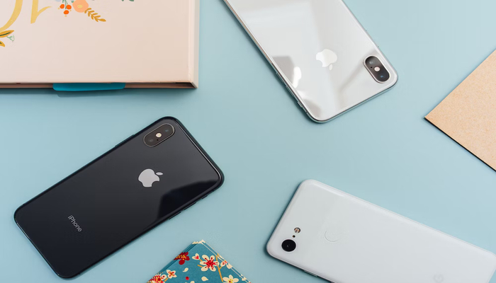 The image shows various iPhone models. — Unsplash