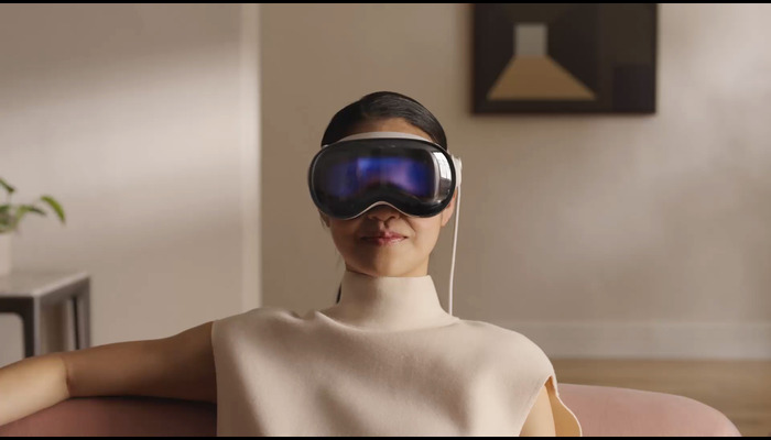 The image shows a girl wearing a Vision Pro headset. — Apple