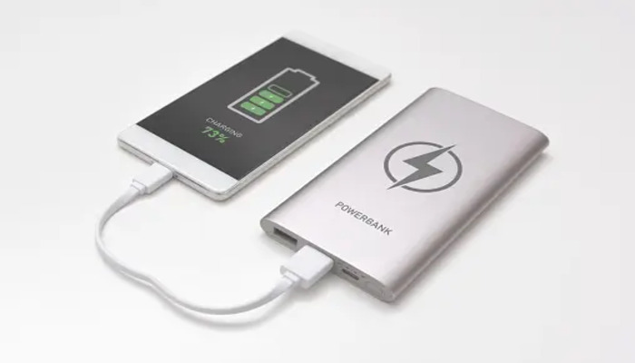 A representational image of a smartphone being charged by power bank. — Unsplash