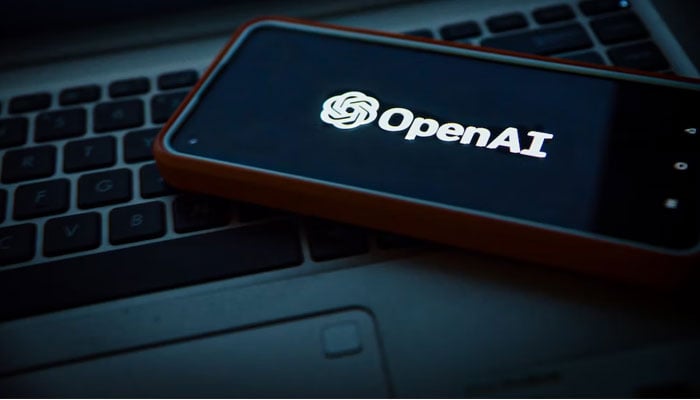 An undated image of a phone screen displaying the OpenAI logo. — Unsplash