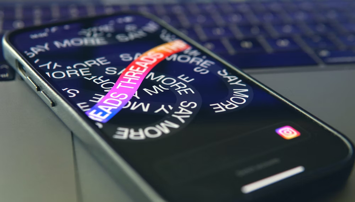 A representational image displaying Threads logo on a mobile screen. — Unsplash/file