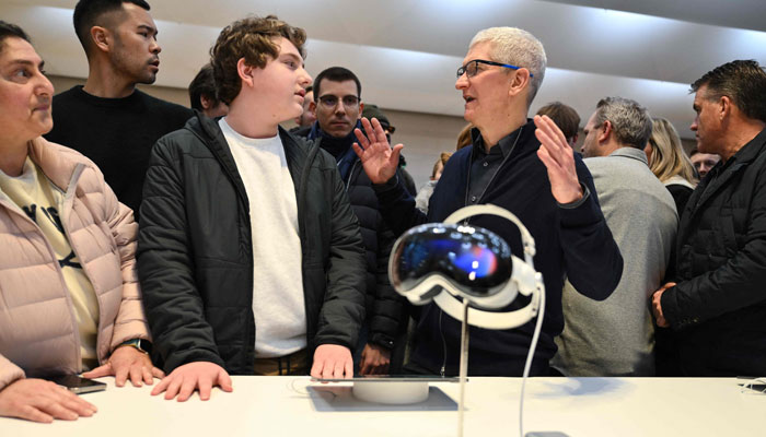 Apple CEO Tim Cook speaks with customers as he attends the product launch for the Apple Vision Pro headset at the Apple Store in New York City on February 2, 2024. — AFP