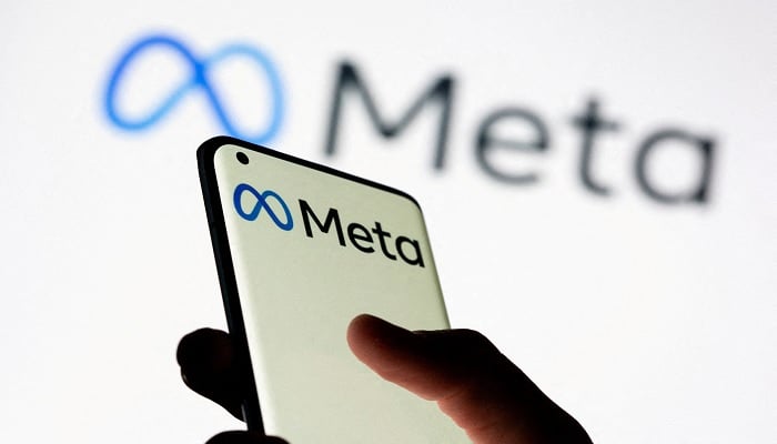 The image shows Meta written on a phone screen. — Reuters