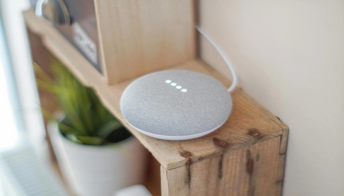 The image shows a round grey speaker. — Pexels