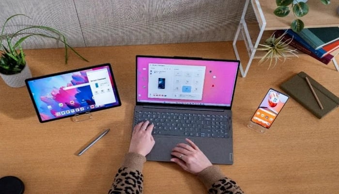 The image shows a person using Lenovo laptop. — Lenovo