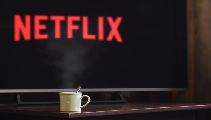 The image displays Netflix logo on a screen. — Pexels