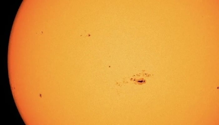 The image is a zoomed-in photo of the sun and shows sun spots. — NASA