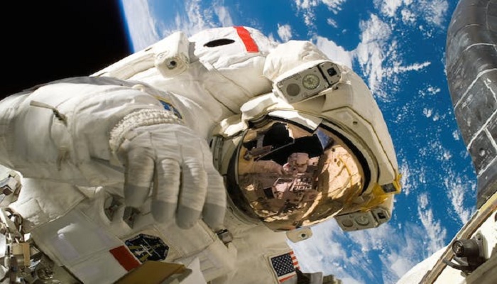 The image is a stock photo of an astronaut. — Pexels