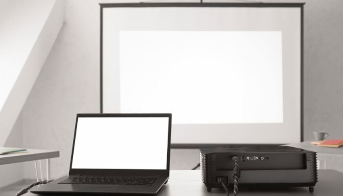 A representational image of a laptop and a projector.—Canva