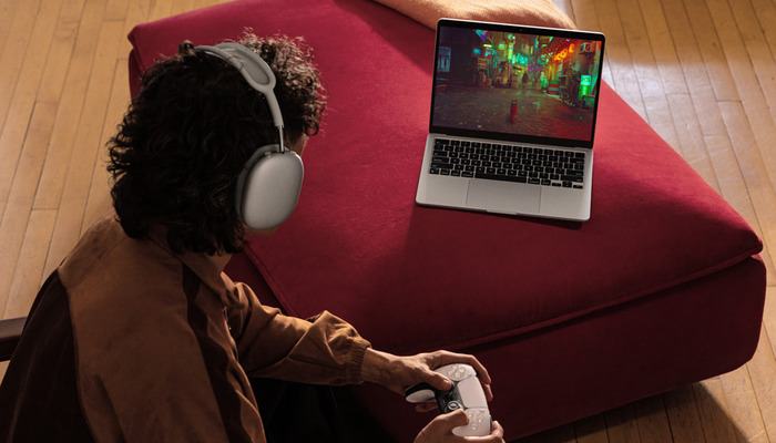 An undated image of a person playing games on M3 MacBook Air. — Apple